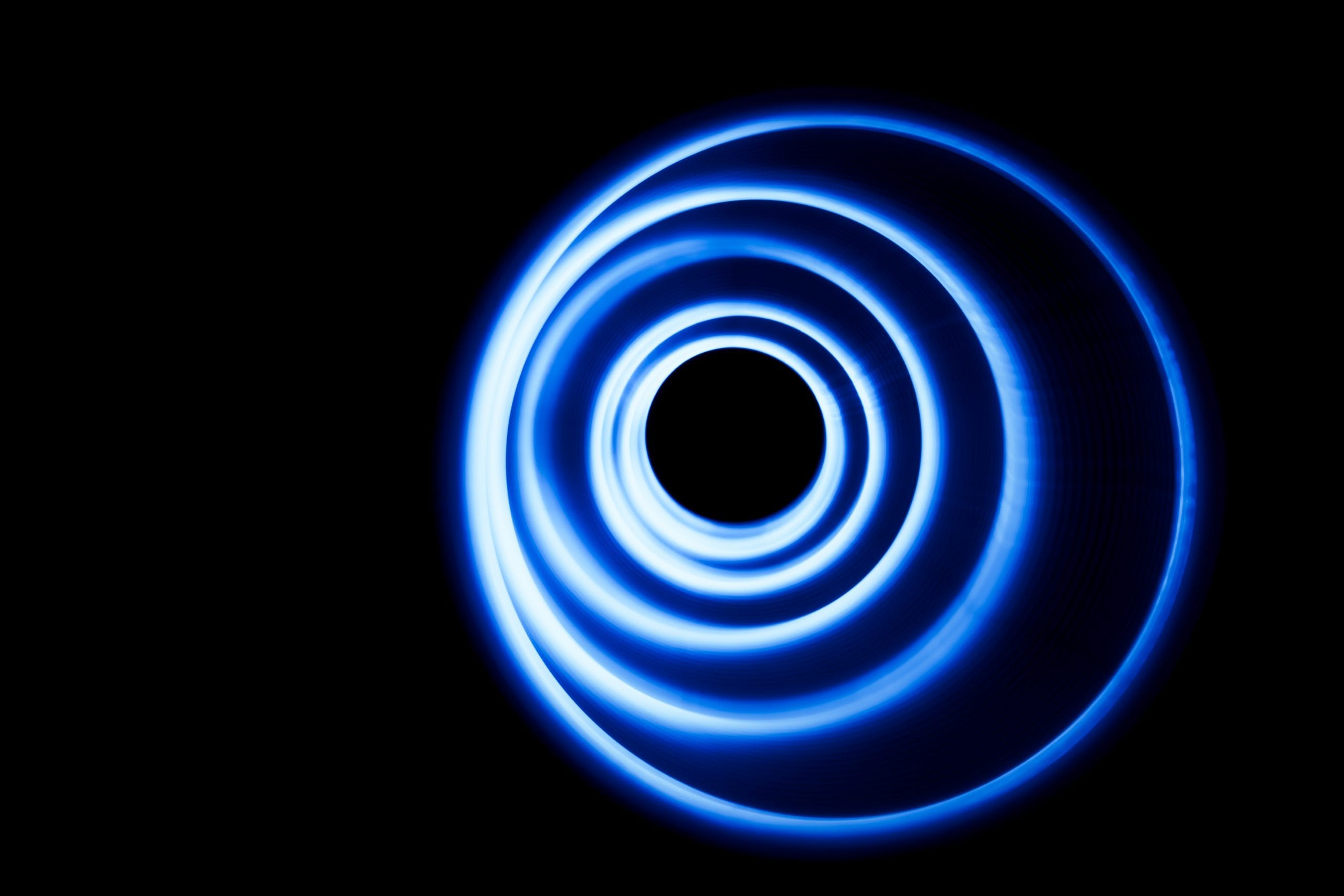 A mesmerizing blue spiral pattern against a black background.