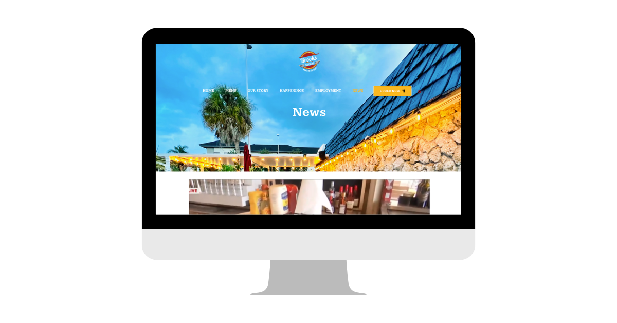A computer screen displaying a vibrant restaurant website with news updates.