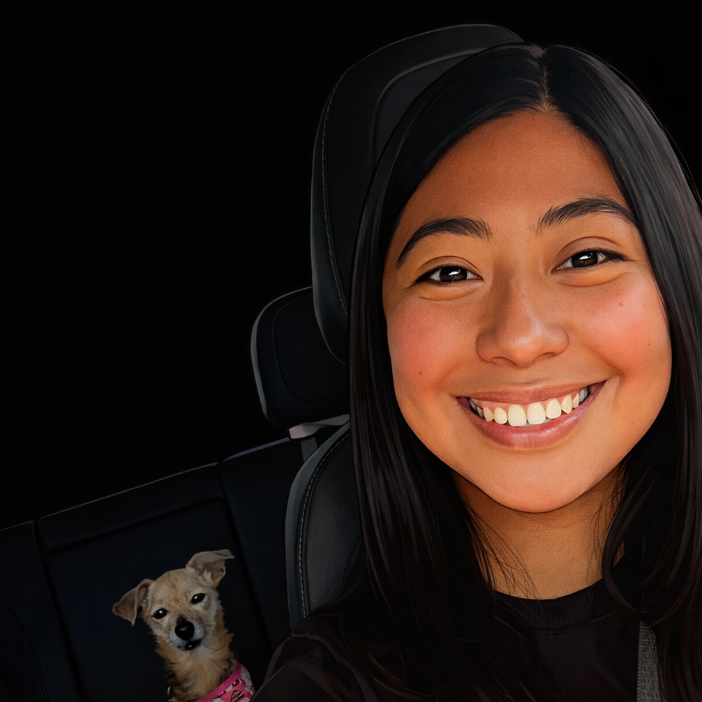 A young woman smiling in a car with a small dog in the background.