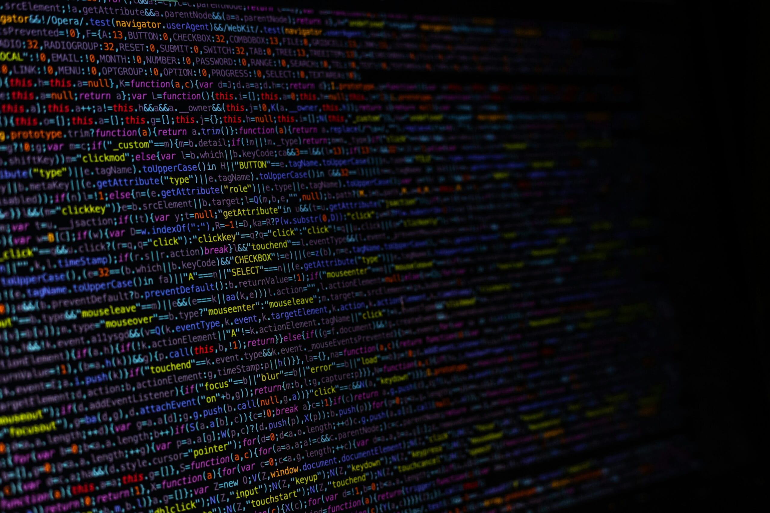 Colorful lines of code displayed on a dark screen.
