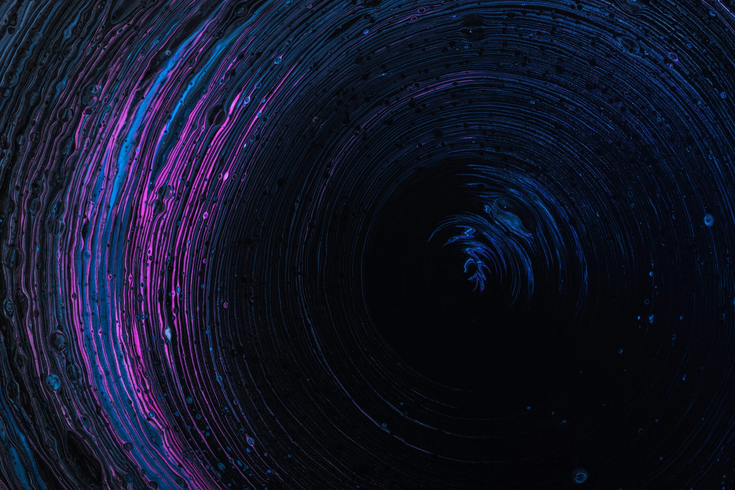 Abstract swirling patterns in dark blue and purple tones.