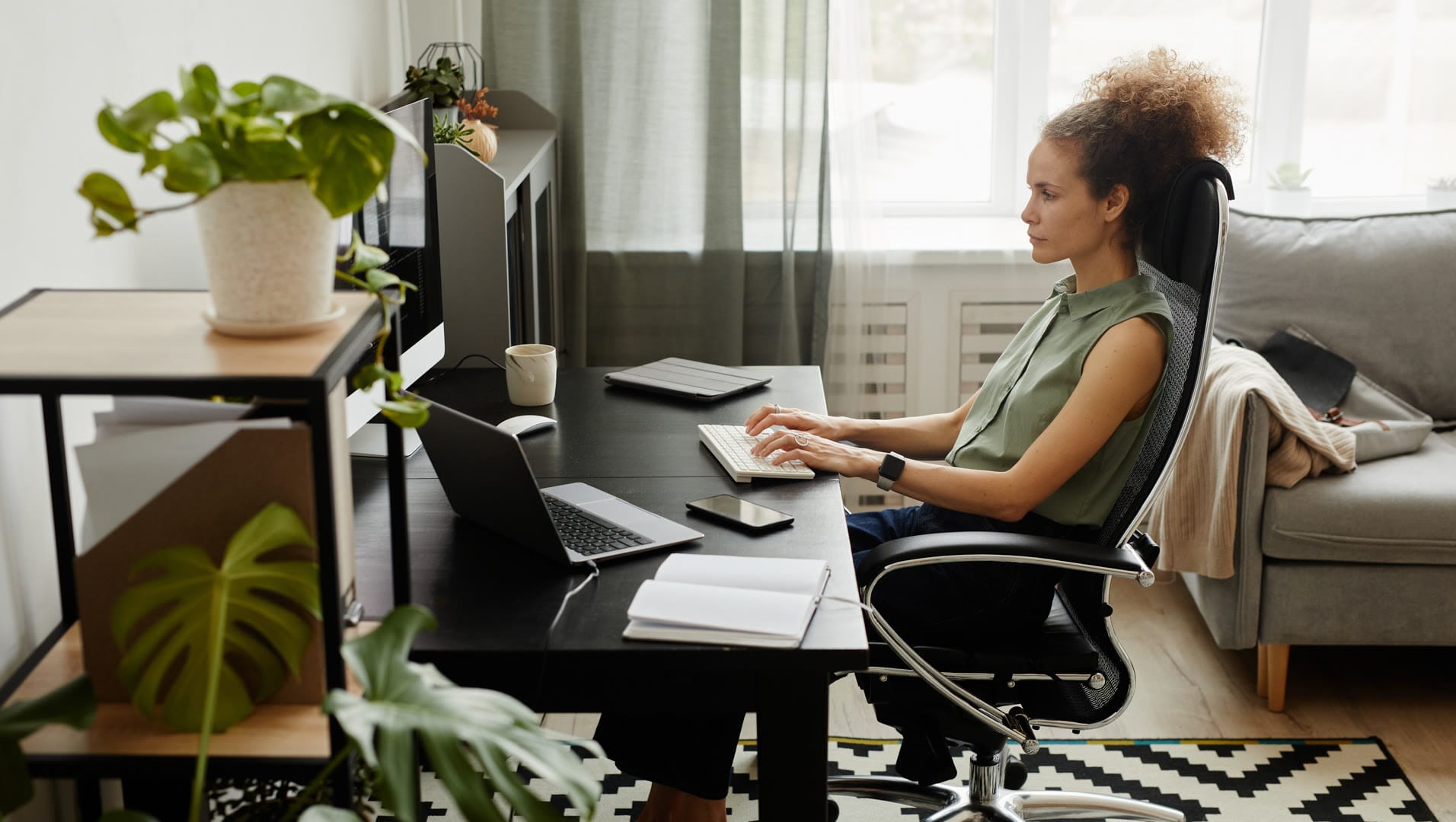 A digital marketing expert at Solve Design Create working on a laptop, crafting effective Call-to-Action strategies for Naples businesses.
