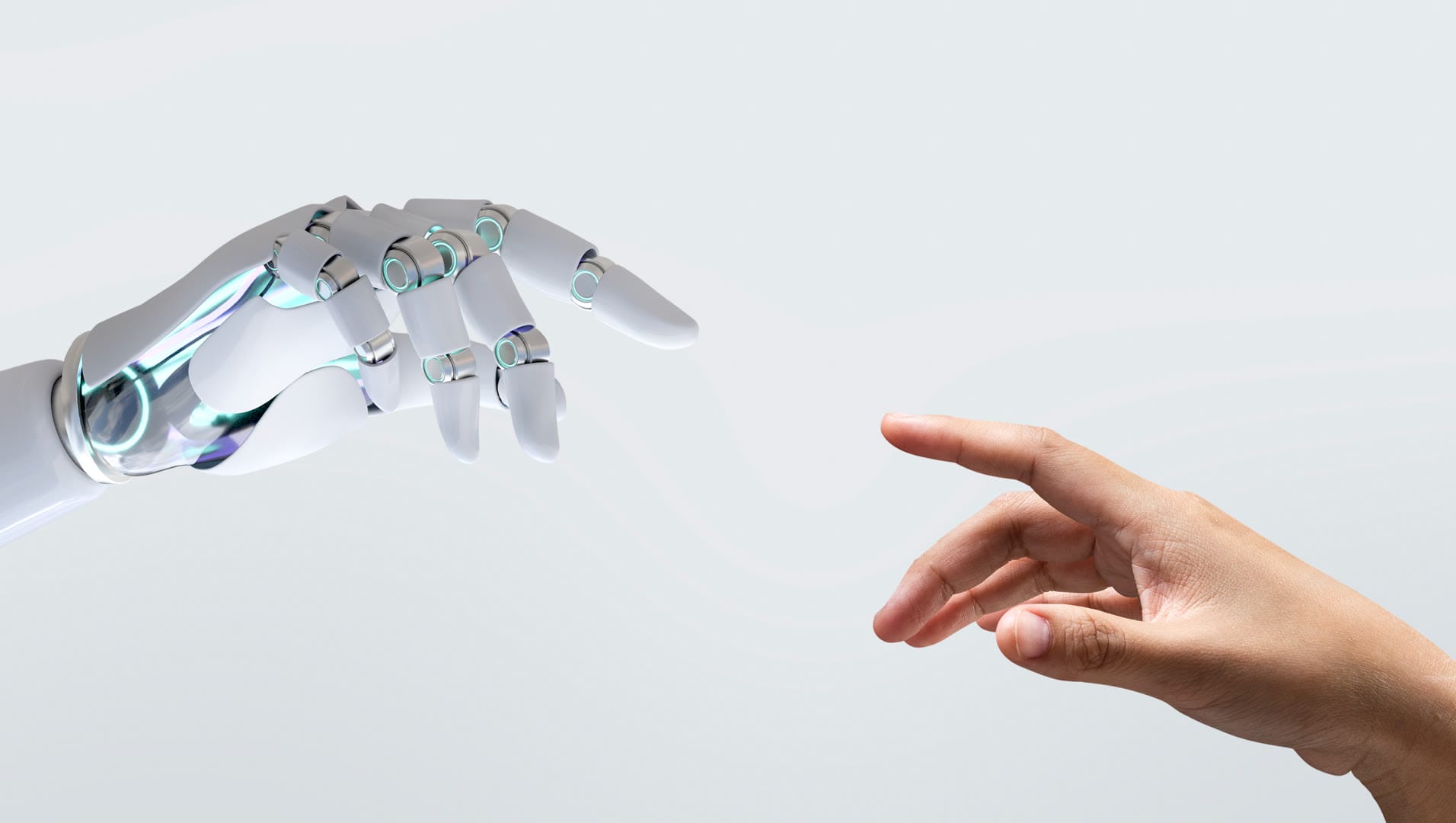 A robotic hand reaching towards a human hand in a symbolic gesture.