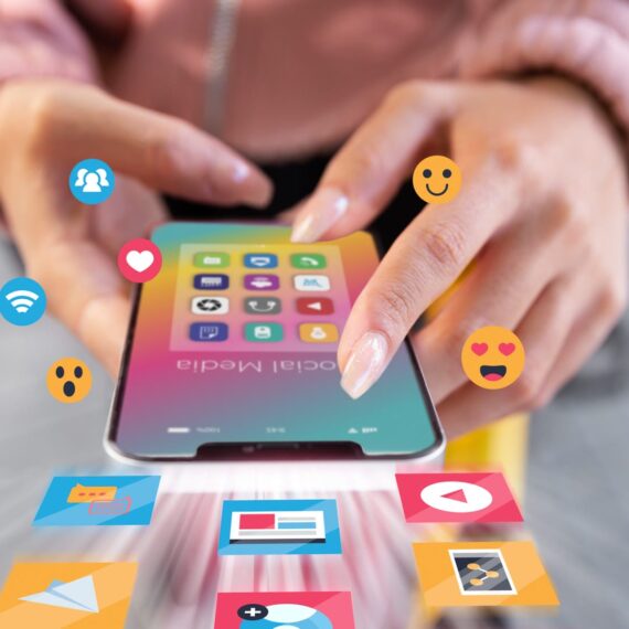 A person interacting with a smartphone displaying various social media icons.