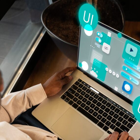 Person working on a laptop displaying UI and UX design elements.