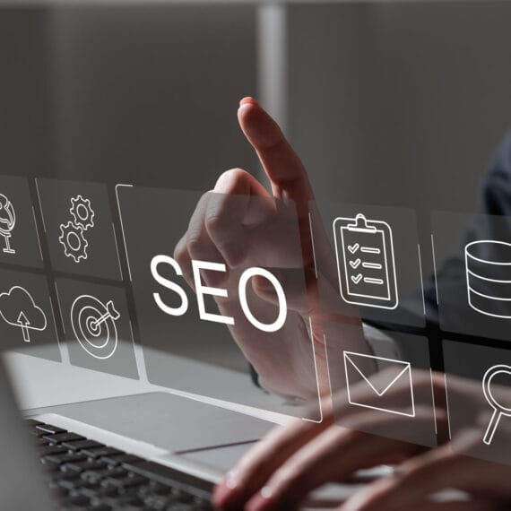A graphic representing SEO web design services by Solve Design Create, showcasing a computer screen displaying a beautifully designed website alongside SEO analytics charts