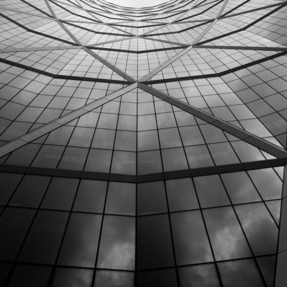 Abstract geometric reflection of a modern building in black and white.
