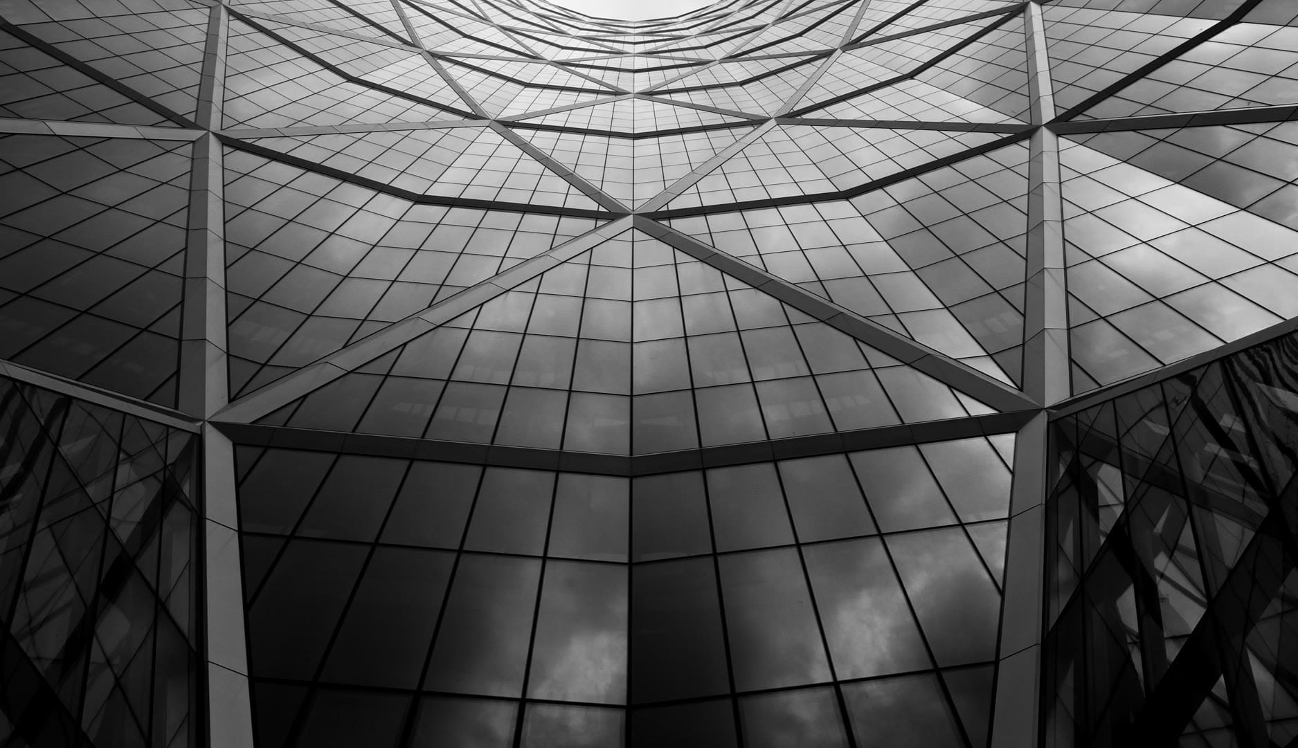 Abstract geometric reflection of a modern building in black and white.
