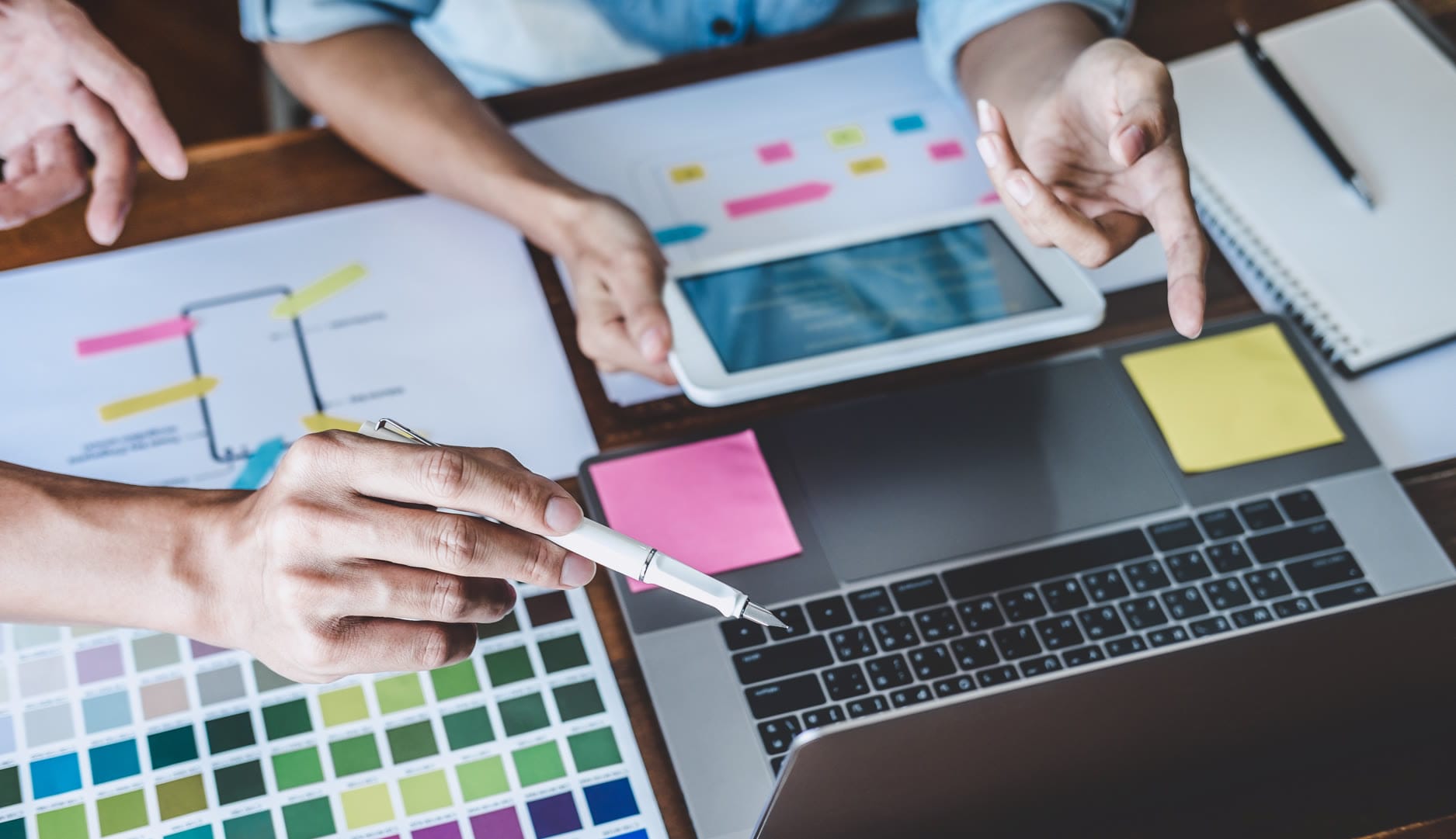 Image depicting a digital marketing professional designing a custom web layout on a tablet, representing the creation of a robust content system for Naples businesses.