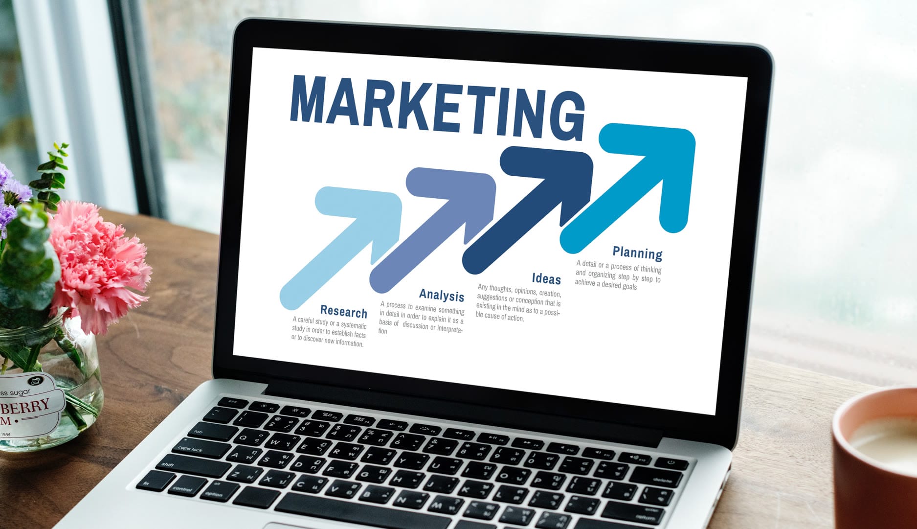Custom web design display on a laptop screen with Naples, FL beach background