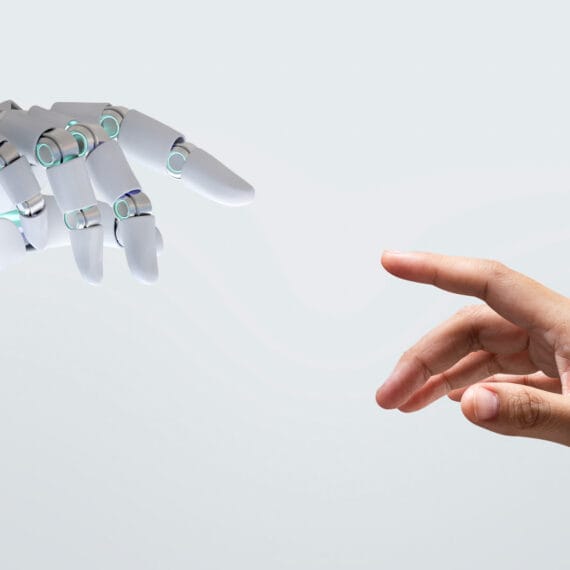 A creative professional analyzing AI data insights on a digital dashboard, symbolizing AI-driven transformation in business operations.