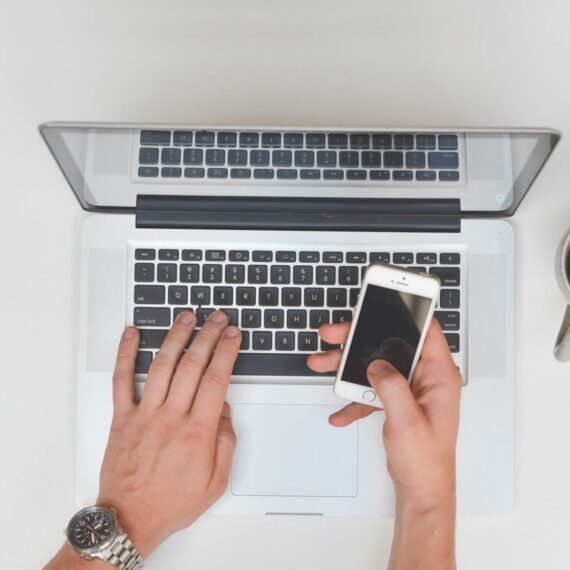 A graphic showing a web designer optimizing a client's website performance on a laptop, symbolizing digital marketing services in Naples, Florida